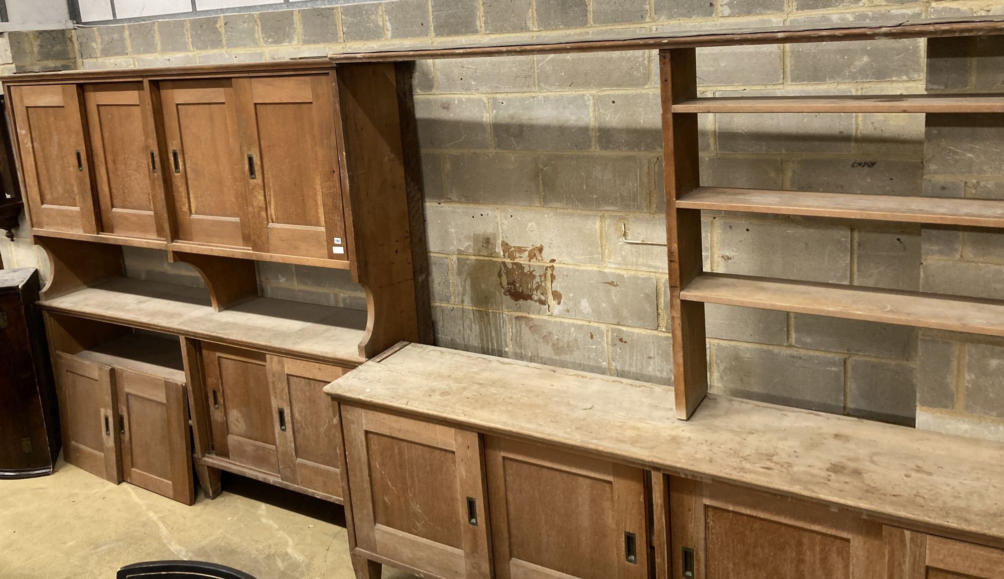 Two mid century pine and fruitwood sliding door household cupboards, larger 245cm, depth 47cm, height 204cm